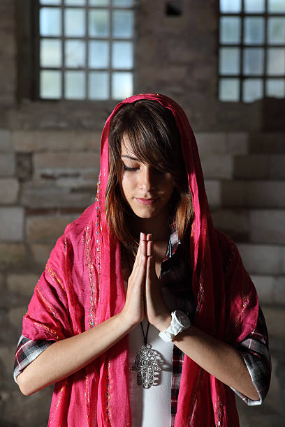 istock Young girl praying 153016874