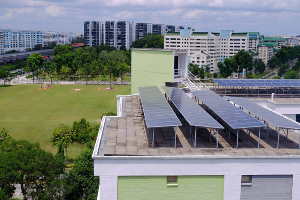 Common to see solar panels installed on roof tops of HDB blocks in Singapore to harness green energy; the aim to being carbon-neutral Common to see solar panels installed on roof tops of HDB blocks in Singapore to harness green energy; the aim to being carbon-neutral. solar panels on the roof of building in a city stock pictures, royalty-free photos & images
