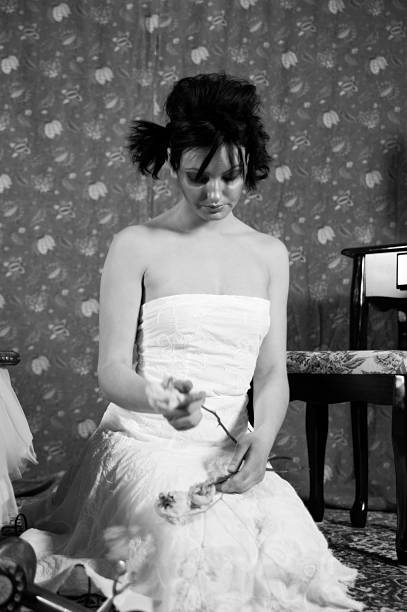 istock Unhappy Young Girl Holding Dead Roses 153017342