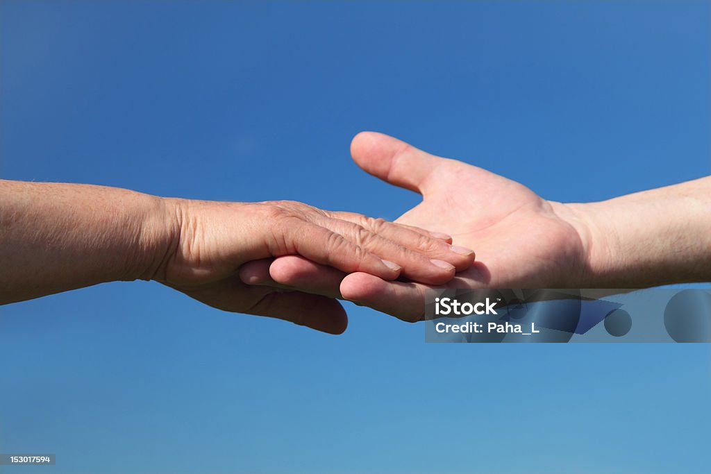 Closeup of old people holding for hands Closeup of old people holding for hands, blue sky Couple - Relationship Stock Photo