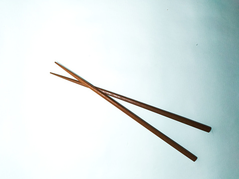 Wooden chopstick on bright background. Sumpit