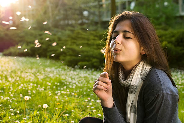 istock Cute girl playing with a dandelion outside 153017844