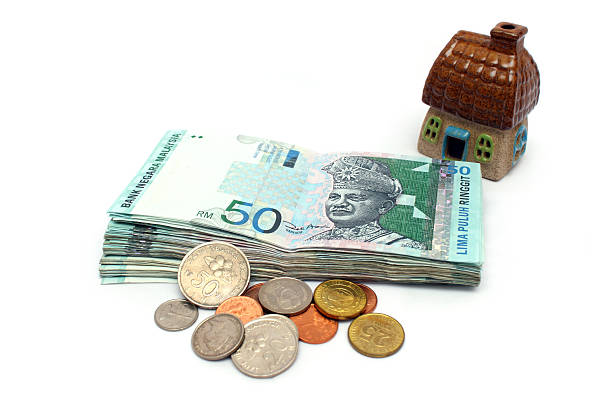 Money is Property Malaysia banknote and mixed coins with a house. coins of ringgit of malaysia stock pictures, royalty-free photos & images