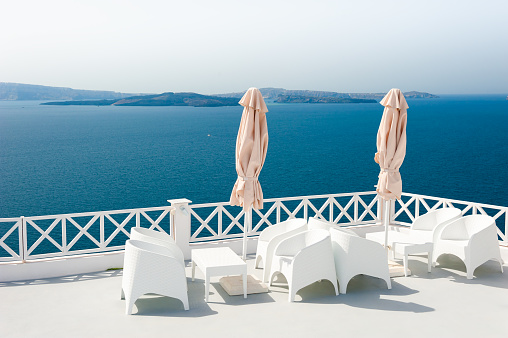 White architecture in Santorini island, Greece. Beautiful terrace with sea view. Travel and vacations concept