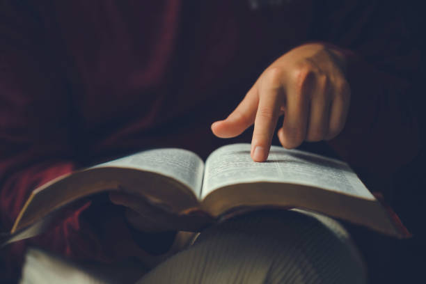 istock Christian man's hands while reading the Bible outside.Sunday readings, Bible education. spirituality and religion concept. Reading a book.education learning 1530193444