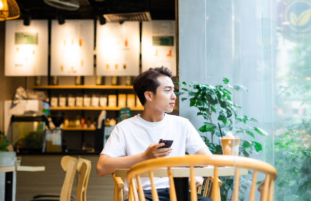 istock Asian man sitting at coffee shop 1530198663