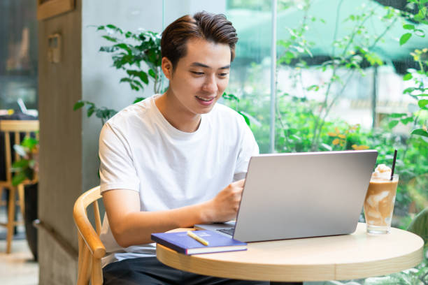 istock Asian man sitting at coffee shop 1530199695