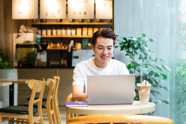 istock Asian man sitting at coffee shop 1530199706