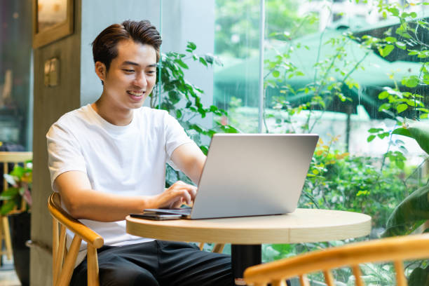 istock Asian man sitting at coffee shop 1530200766