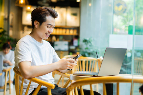 istock Asian man sitting at coffee shop 1530200774