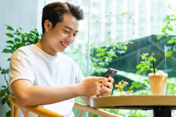 istock Asian man sitting at coffee shop 1530201308