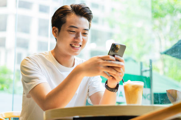 istock Asian man sitting at coffee shop 1530201852