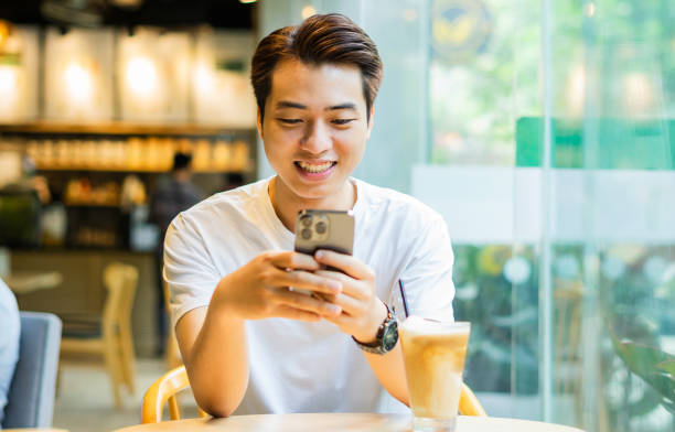 istock Asian man sitting at coffee shop 1530202024