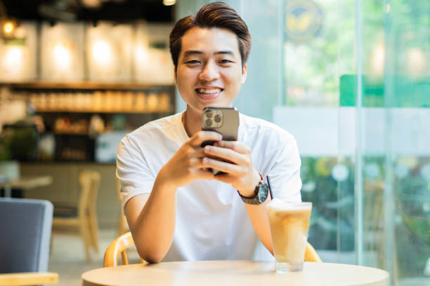 istock Asian man sitting at coffee shop 1530202369