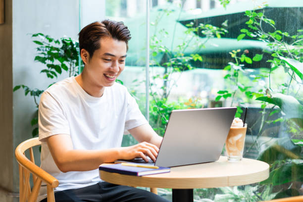 istock Asian man sitting at coffee shop 1530202372