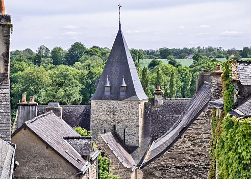 Elevated view of a church and rooftops in Rochefort-en-Terre, Brittany, France.