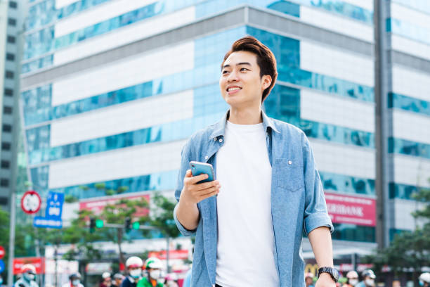 istock Asian man walking on the street 1530214463