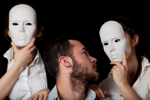 Be yourself - young man holding a white mask next to his face - concept for being real and not fake