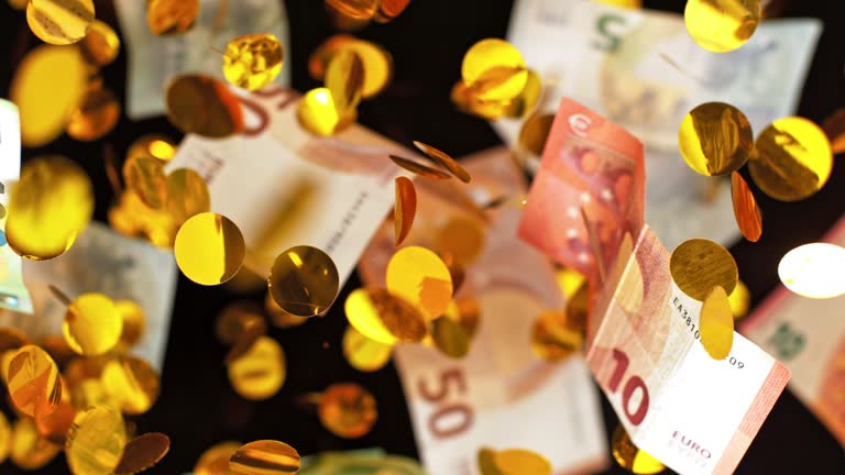 SLO MO LD Euro banknotes and golden confetti flying in the air