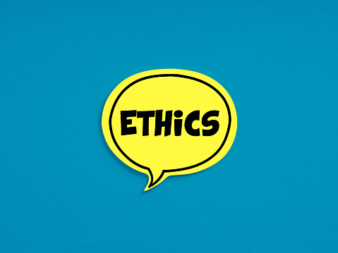 The word ethics on yellow speech bubble on blue background. Code of Ethics, morality, moral rules or ethical Integrity in business concept.