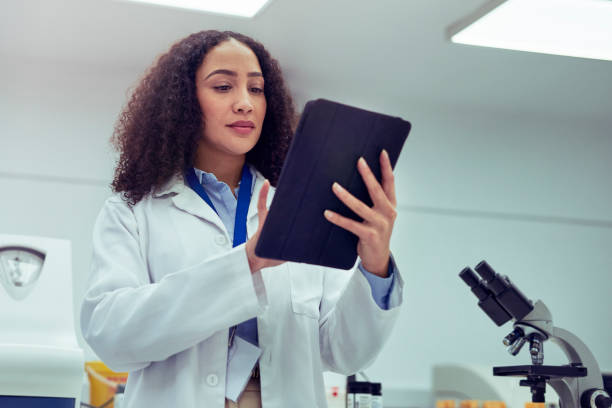 istock Low angle view of female scientist using digital tablet in laboratory 1530246395