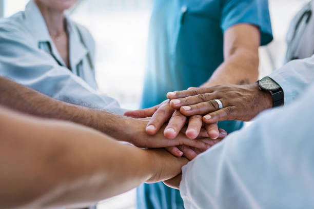 istock Close-up of medical team stacking hands 1530248685