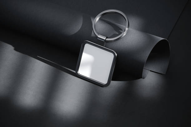 istock Square keychain near black paper scroll mockup. 3D rendering 1530249223