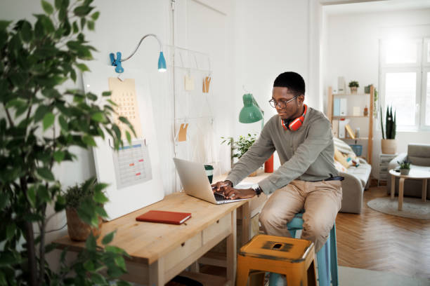 istock Young casually clothed man using laptop at home office 1530250907