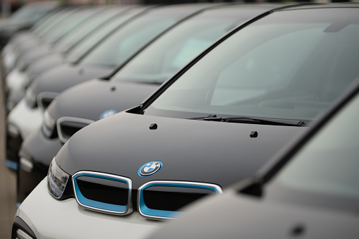 Hamburg, Germany - July 09. 2023: 
A row of used BMW i3 cars at a public car dealership on the outskirts of Hamburg. The BMW i3 is an electric car or plug-in hybrid vehicle from the automobile manufacturer BMW in the small car class