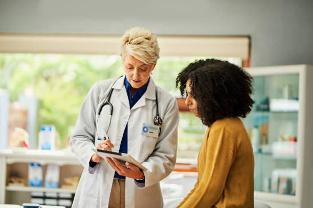 istock Doctor explaining test results on digital tablet to patient in clinic 1530259421