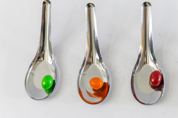 istock Candy in a spoon, orange, green, sugar, on a white background. 1530299469