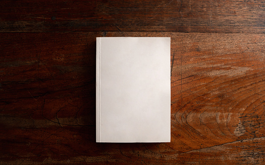 Blank lined notepad made of recycled paper with pen, white wood background