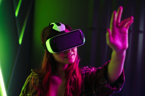 istock Female gamer exploring a digital world using a VR headset 1530339067