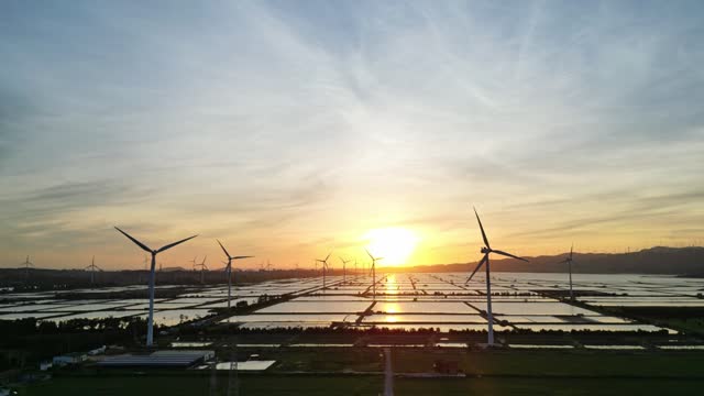 Aerial view of the wind farm at the beach fish farm at sunrise