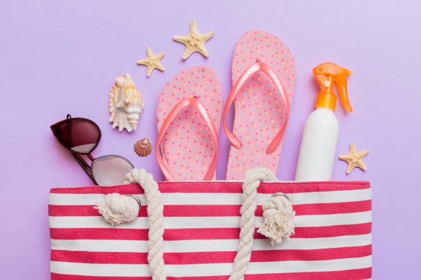 istock beach accessories flat lay top view on colored background Summer travel concept. Bag with starfish and sea shell. Top view 1530354157