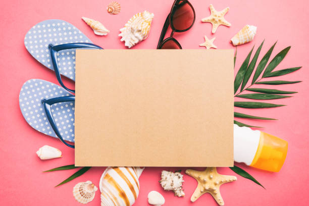 istock Summer time concept with blank greeting card and blank craft paper on colored background. Seashells from ocean shore in the shape of frame separated with space for text top view 1530354231