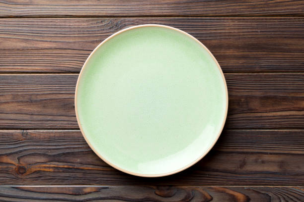 istock Top view of empty blue plate on wooden background. Empty space for your design 1530354251