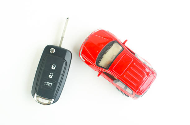 istock Small toy car and Remote control car key 1530363926