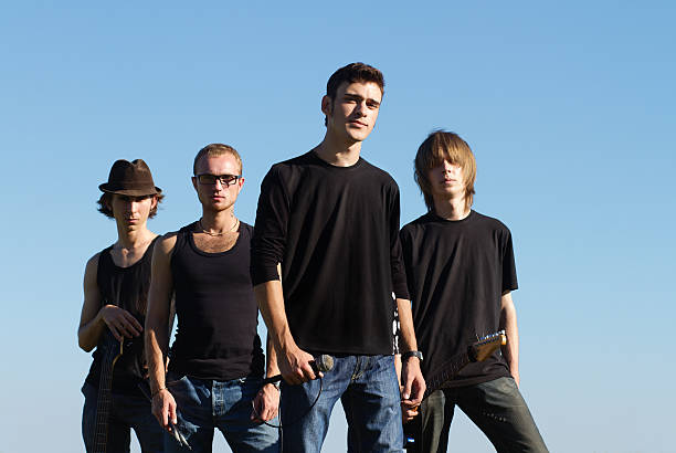 Young rockstars posing Serious young rockers posing with instruments outdoors performance group photos stock pictures, royalty-free photos & images