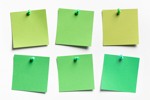 Group of green Sticky notes on white paper background. This file is cleaned and retouched.