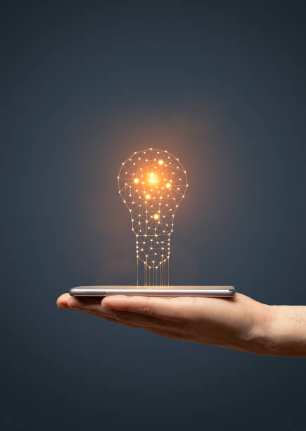 istock Idea concept with hand holding smartphone with glowing light bulb 1530376903