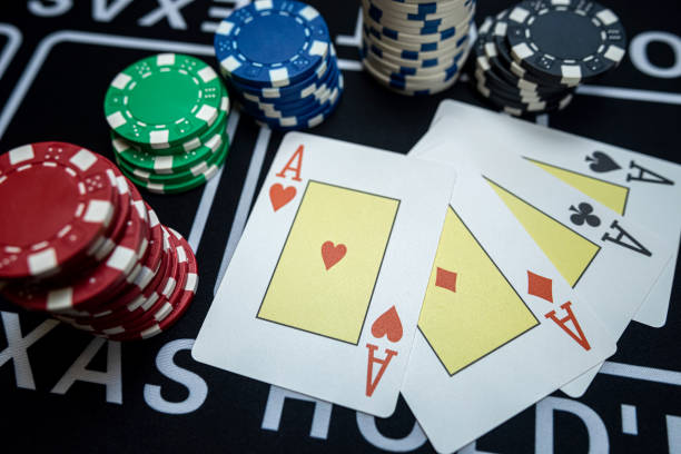 istock Four Ace playing cards with chips on casino table 1530380379