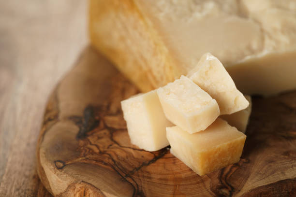 istock hard parmesan cheese cubes on olive cutting board 1530393638
