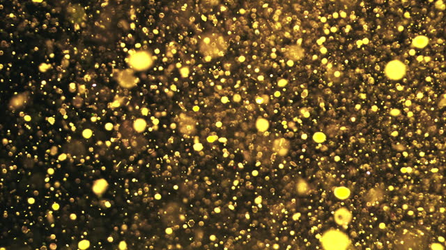 SLO MO LD Golden glitter flying in the air
