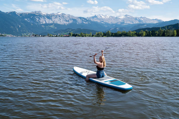 istock Young woman swimming on paddle board, sity pond 1530416057