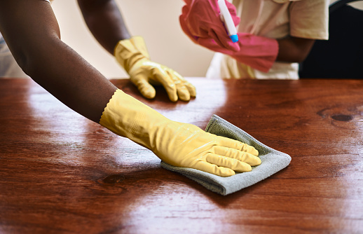 father and daughter  cleaning the table wearing gloves. Stock photo