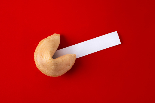 Traditional fortune cookie on red background