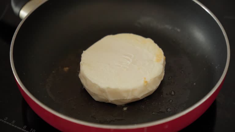 Halloumi cheese frying in grill pan. Cyprus goat cheese fried.