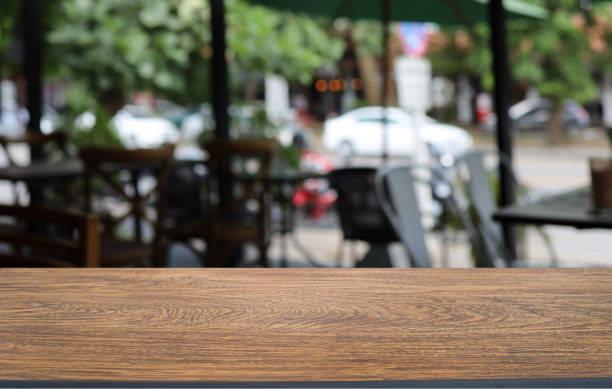 istock Wood table top in front of abstract blurred background. Empty wooden table space for text marketing promotion. blank wood table surface copy space 1530427398