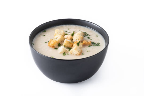 istock Cauliflower soup in a bowl isolated on white background 1530427895